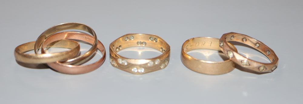 Four 9ct gold rings, including wedding band and three colour Russian triple wedding band, gross 10.1 grams.
